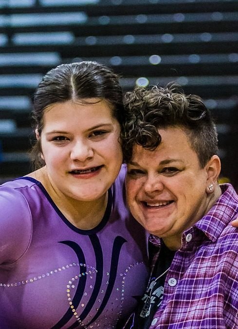 A gymnast and her coach celebrating